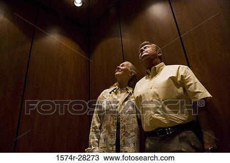 Business people looking at lights in an office View Large Photo Image Stock Image - Business people looking at lights in an office. Fotosearch