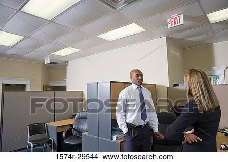 Business people standing in an office View Large Photo Image Picture - Business people standing in an office. Fotosearch