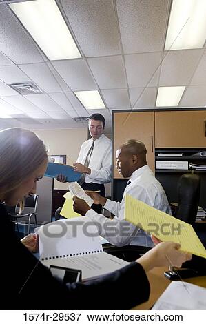 Business people working in an office View Large Photo Image Stock Photo - Business people working in an office. Fotosearch