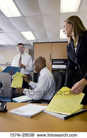 Business people working in an office View Large Photo Image Stock Photo - Business people working in an office. Fotosearch
