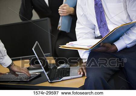 Business people working in an office View Large Photo Image Stock Photo - Business people working in an office. Fotosearch