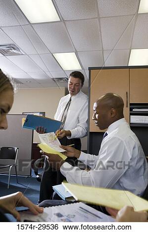 Business people working in an office View Large Photo Image Stock Photograph - Business people working in an office. Fotosearch