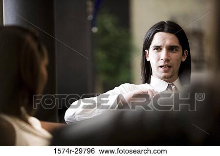 Businessman and a businesswoman in an office View Large Photo Image Stock Photograph - Businessman and a businesswoman in an office. Fotosearch