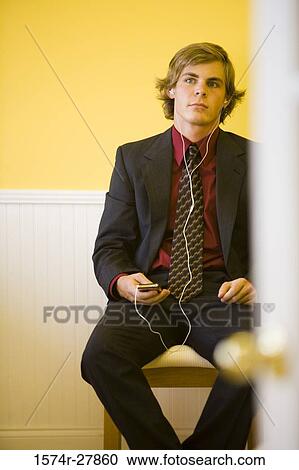 Businessman listening music in an office View Large Photo Image Stock Image - Businessman listening music in an office. Fotosearch