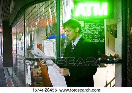 Stock Photography - Businessman reading a newspaper. Fotosearch