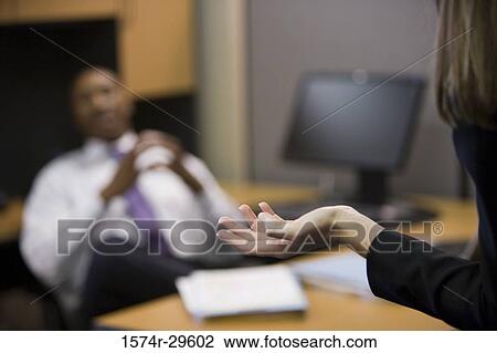 Stock Image - Businessman sitting in an office. Fotosearch