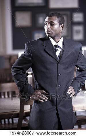 Businessman standing in an office View Large Photo Image Stock Photo - Businessman standing in an office. Fotosearch
