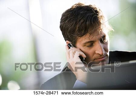 Businessman using cellphone View Large Photo Image Stock Image - Businessman using cellphone. Fotosearch