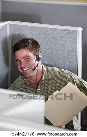 Businessman using headset in an office View Large Photo Image Stock Photograph - Businessman using headset in an office. Fotosearch