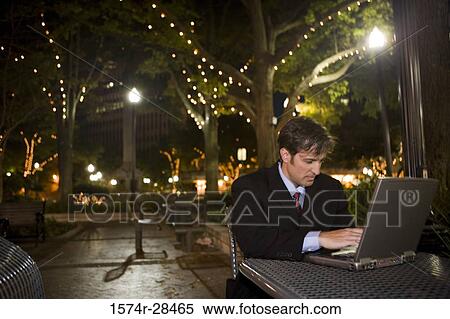 Businessman using laptop computer at night View Large Photo Image Stock Photography - Businessman using laptop computer at night. Fotosearch