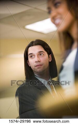 Businessman with colleague in an office View Large Photo Image Stock Photograph - Businessman with colleague in an office. Fotosearch