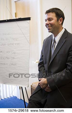 Businessman with holding hands smiling in an office View Large Photo Image Stock Photo - Businessman with holding hands smiling in an office. Fotosearch