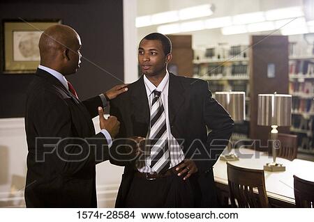 Businessmen conversing in an office View Large Photo Image Picture - Businessmen conversing in an office. Fotosearch