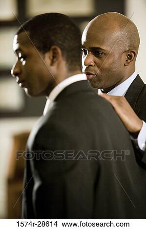 Picture - Businessmen conversing in an office. Fotosearch