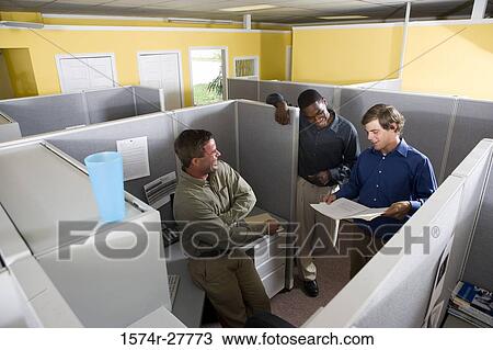 Businessmen conversing in an office View Large Photo Image Stock Image - Businessmen conversing in an office. Fotosearch