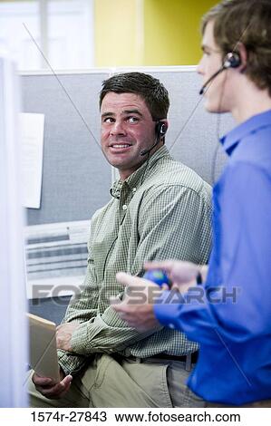Businessmen conversing in an office View Large Photo Image Stock Image - Businessmen conversing in an office. Fotosearch