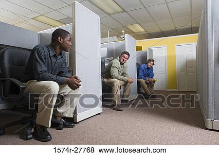 Businessmen conversing in an office View Large Photo Image Stock Photo - Businessmen conversing in an office. Fotosearch