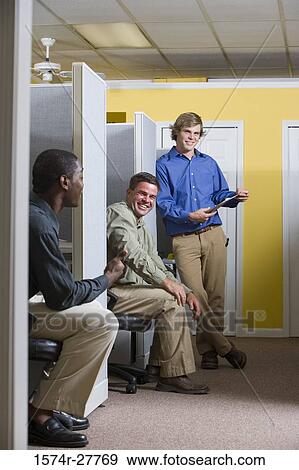 Businessmen conversing in an office View Large Photo Image Stock Photo - Businessmen conversing in an office. Fotosearch