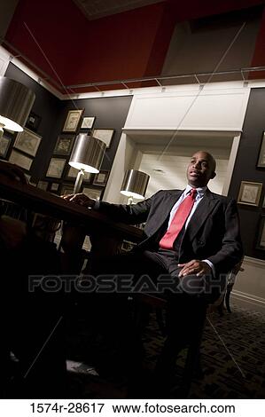 Stock Photo - Businessmen conversing in an office. Fotosearch