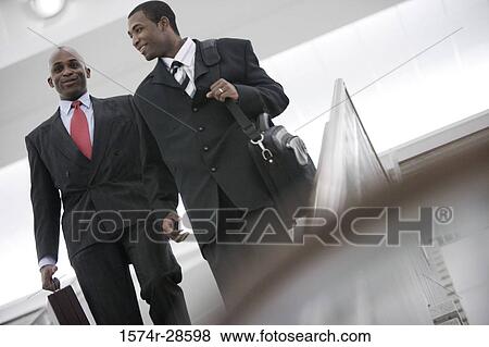 Businessmen conversing on staircase View Large Photo Image Stock Photo - Businessmen conversing on staircase. Fotosearch