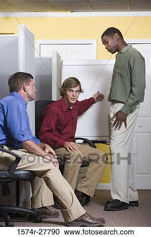 Businessmen in conversation using chart board in an office View Large Photo Image Stock Image - Businessmen in conversation using chart board in an office. Fotosearch