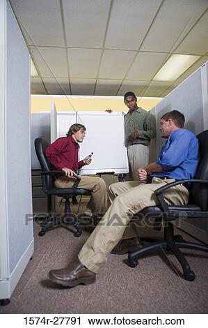 Businessmen in conversation using chart board in an office View Large Photo Image Stock Image - Businessmen in conversation using chart board in an office. Fotosearch