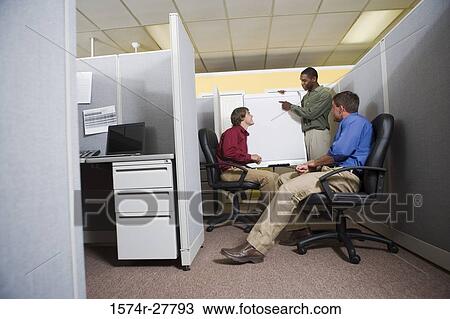 Businessmen in conversation using chart board in an office View Large Photo Image Stock Image - Businessmen in conversation using chart board in an office. Fotosearch
