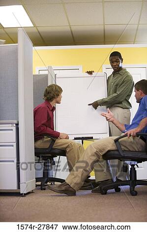 Businessmen in conversation using chart board in an office View Large Photo Image Stock Photo - Businessmen in conversation using chart board in an office. Fotosearch