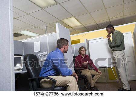 Businessmen in conversation using chart board in an office View Large Photo Image Stock Photograph - Businessmen in conversation using chart board in an office. Fotosearch