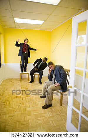 Businessmen in full suit enjoying in an office View Large Photo Image Stock Image - Businessmen in full suit enjoying in an office. Fotosearch