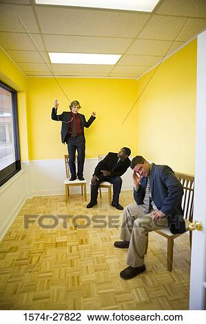 Businessmen in full suit enjoying in an office View Large Photo Image Stock Image - Businessmen in full suit enjoying in an office. Fotosearch