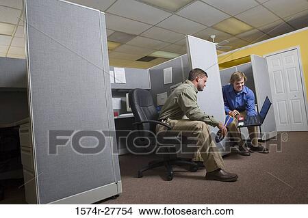 Businessmen looking at a laptop View Large Photo Image Picture - Businessmen looking at a laptop. Fotosearch