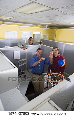 Businessmen playing with ball in an office View Large Photo Image Stock Image - Businessmen playing with ball in an office. Fotosearch