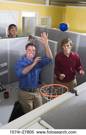 Businessmen playing with ball in an office View Large Photo Image Stock Photography - Businessmen playing with ball in an office. Fotosearch