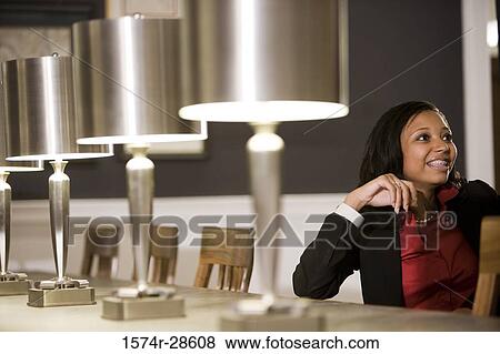 Businesswoman sitting on chair in an office View Large Photo Image Stock Photo - Businesswoman sitting on chair in an office. Fotosearch
