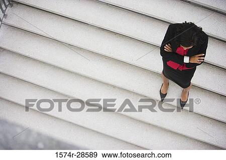 Stock Photo - Businesswoman standing on staircase. Fotosearch