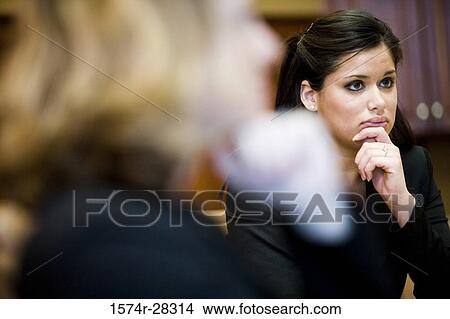 Picture - Businesswomen attending meeting in an office. Fotosearch