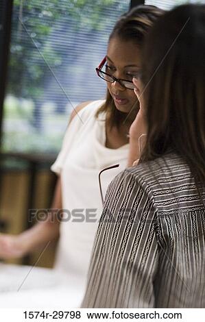 Stock Photo - Businesswomen sitting in office. Fotosearch
