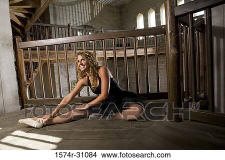 Cheerful ballet dancer exercises on hardwood floor View Large Photo Image Picture - Cheerful ballet dancer exercises on hardwood floor. Fotosearch