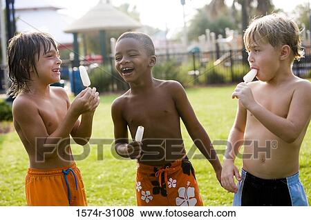 Cheerful bare chested boys eating flavored ice View Large Photo Image Stock Photo - Cheerful bare chested boys eating flavored ice. Fotosearch