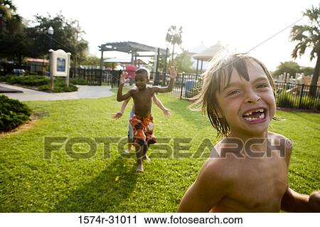 Cheerful bare chested boys playing on grass View Large Photo Image Stock Image - Cheerful bare chested boys playing on grass. Fotosearch