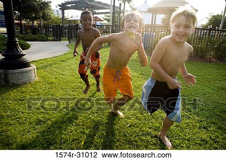 Cheerful bare chested boys running on grass View Large Photo Image Stock Image - Cheerful bare chested boys running on grass. Fotosearch