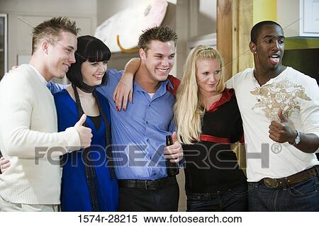 Cheerful friends giving 'thumbs up' sign View Large Photo Image Stock Photography - Cheerful friends giving 'thumbs up' sign. Fotosearch