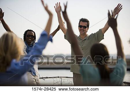 Cheerful friends with arms raised View Large Photo Image Stock Photography - Cheerful friends with arms raised. Fotosearch