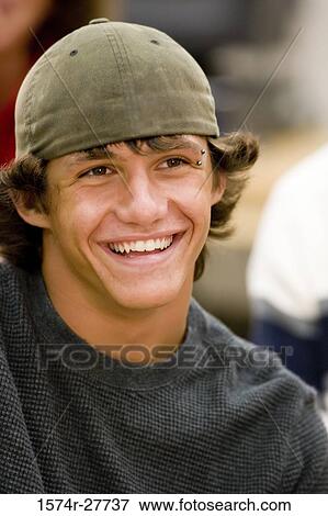 Cheerful male student wearing a cap View Large Photo Image Stock Photo - Cheerful male student wearing a cap. Fotosearch