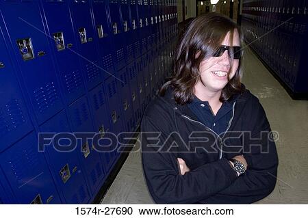 Cheerful male student wearing sunglasses and standing by lockers View Large Photo Image Stock Image - Cheerful male student wearing sunglasses and standing by lockers. Fotosearch