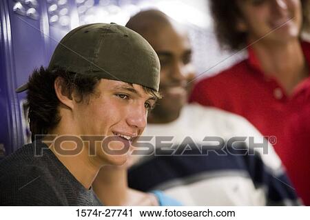 Cheerful male students by lockers View Large Photo Image Stock Image - Cheerful male students by lockers. Fotosearch