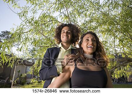 Cheerful mature woman and a young man standing together View Large Photo Image Stock Photograph - Cheerful mature woman and a young man standing together. Fotosearch
