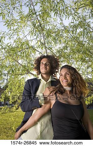 Cheerful mature woman and a young man standing together View Large Photo Image Stock Photography - Cheerful mature woman and a young man standing together. Fotosearch