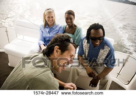 Cheerful mid adult couples enjoying in the boat View Large Photo Image Stock Photo - Cheerful mid adult couples enjoying in the boat. Fotosearch